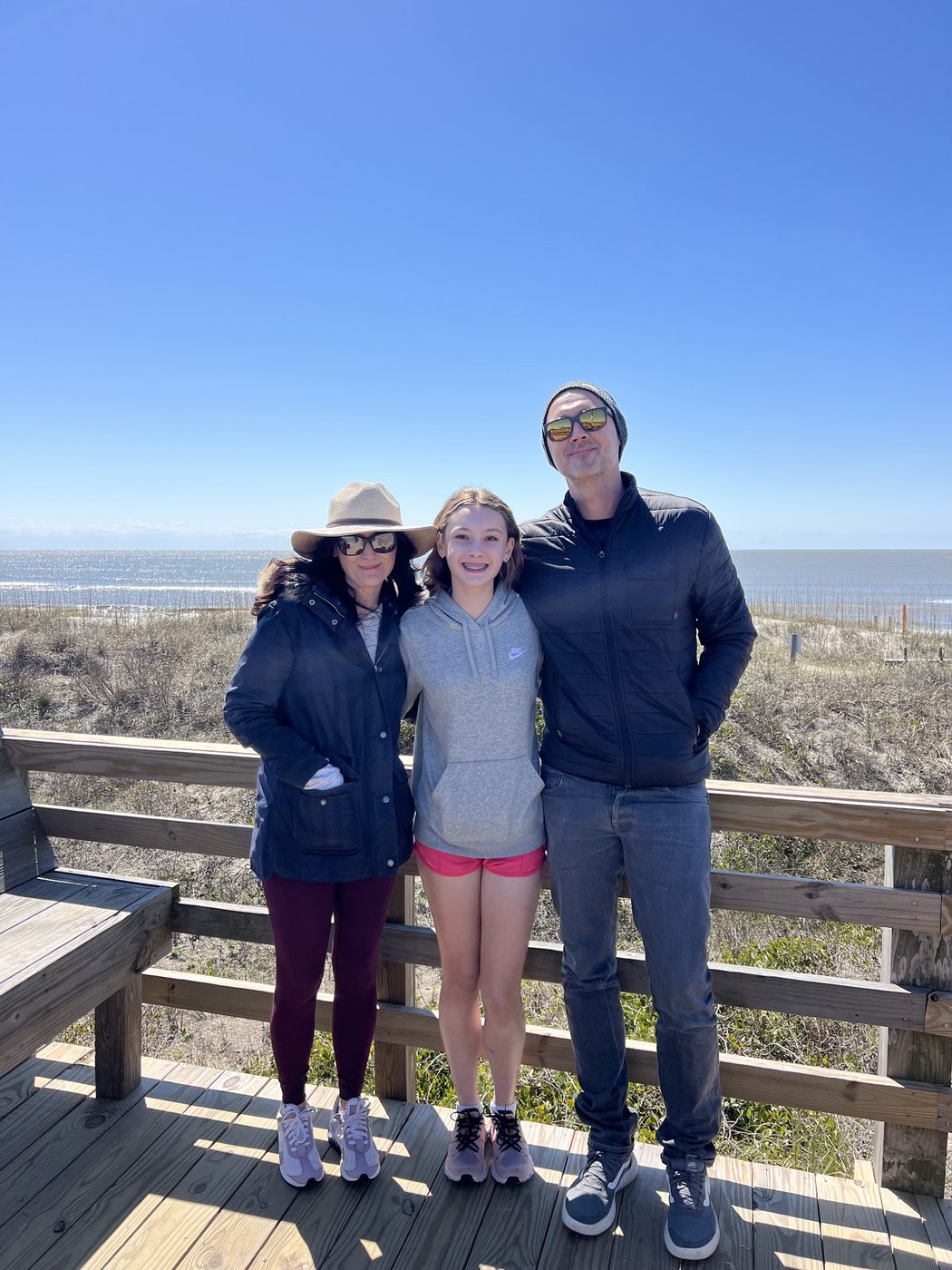Ian Hart with his family on a beach boardwalk